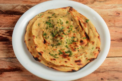 lachha-paratha-layered-flat-bread-using-wheat-flour-popular-dish-north-india-isolated-rustic-wooden-background-selective-focus_726363-707